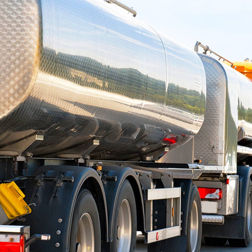 A truck with liquid oil storage driving down the highway. 